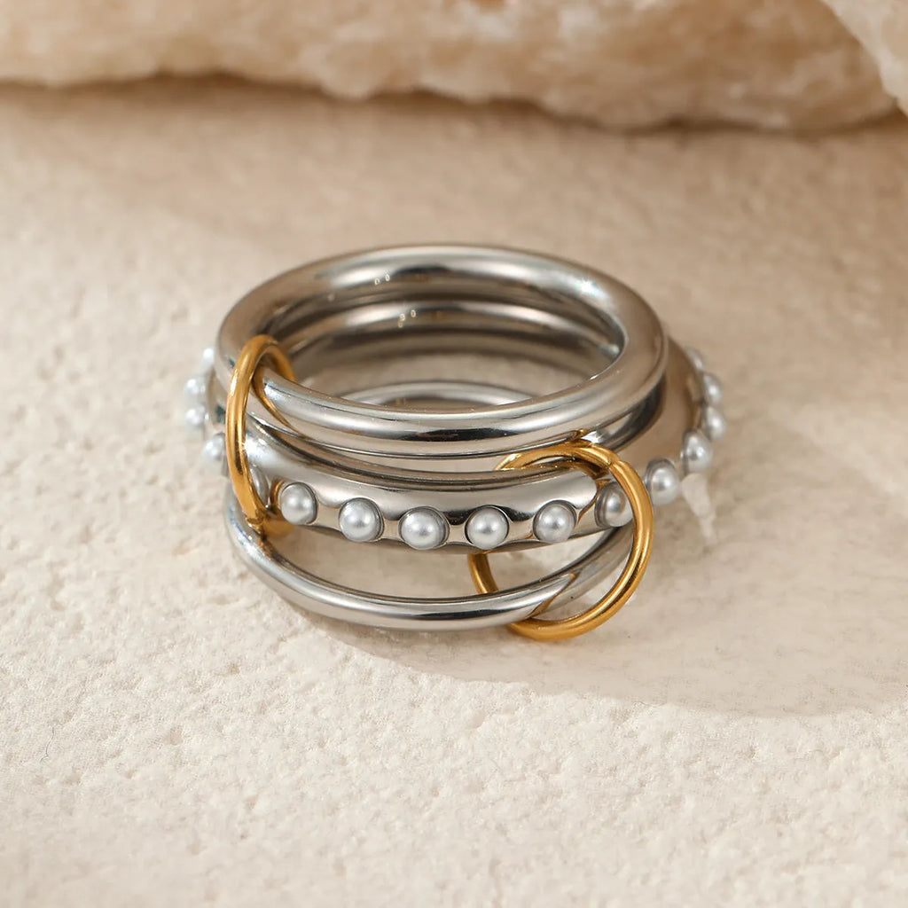 Stacked stainless steel ring set with 18K gold plating, exaggerated design for women.