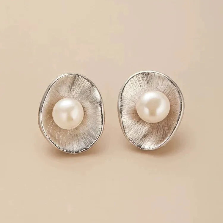 Pearl sterling silver needle earrings with gold electroplated finish and geometric design