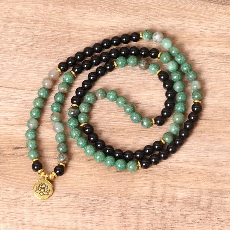 Green and black alloy elastic beaded bracelet showing alternating colours on wrist