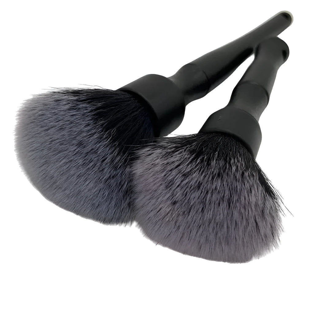 Black ultra-soft pig hair car detailing brush with PP plastic handle on a car seat.