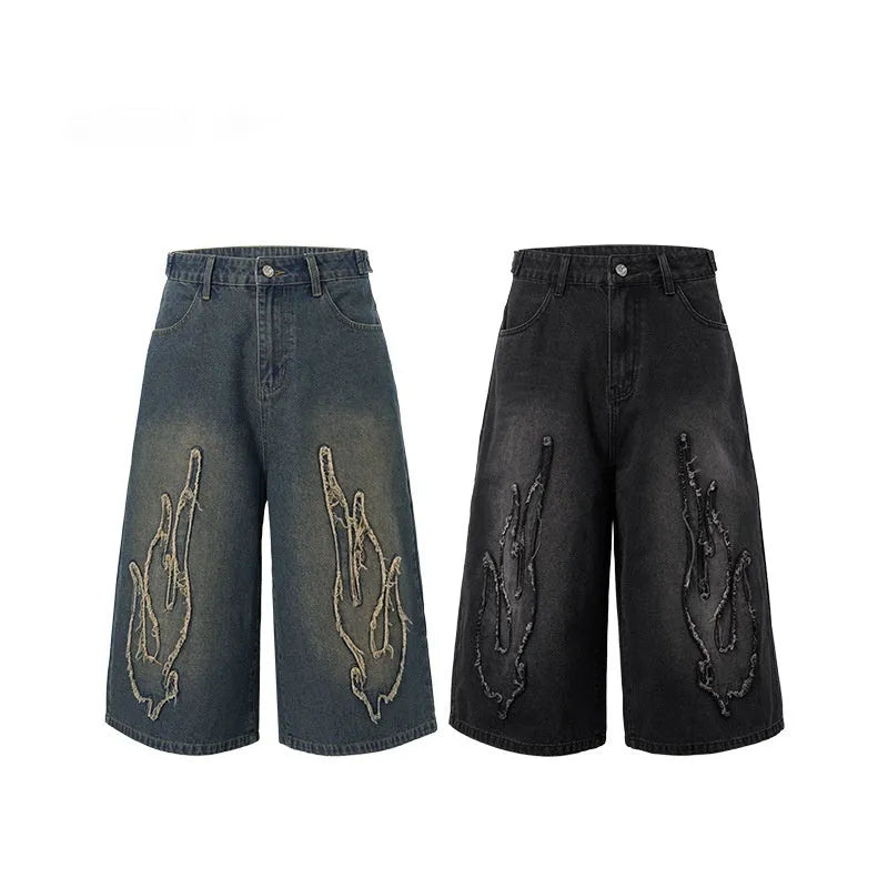 Men's black denim shorts with flame embroidery patch on straight leg cropped design