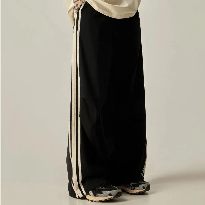 Man wearing black high-waist wide leg climbing pants made from polyester for casual leisure wear.