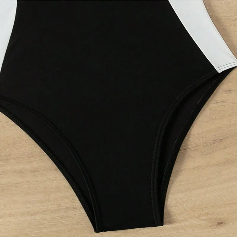 Black and white women's slim fit one-piece swimsuit with pearl spaghetti straps.