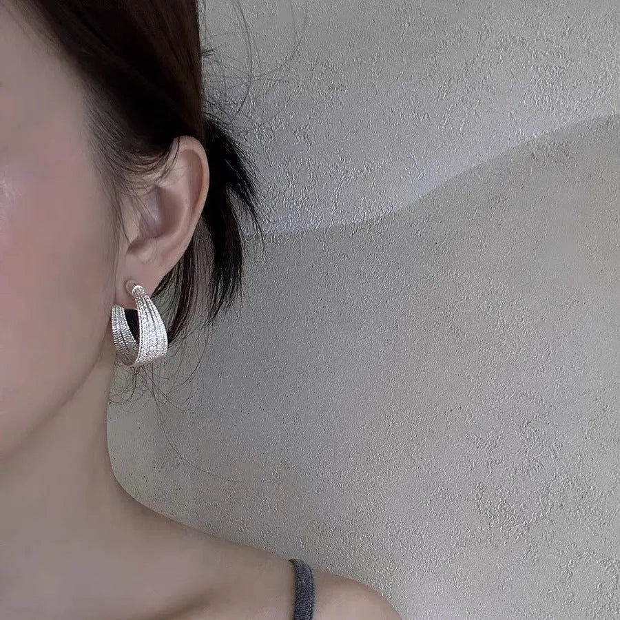 Multi-layer geometric copper earrings with electroplated gold or silver finishes, available as stud or clip styles