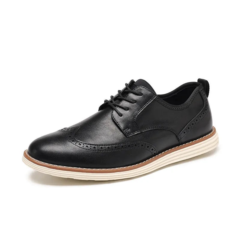 Men's black slip-on business casual shoes with round toe and carved detail on a white background.