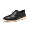 Men's black slip-on business casual shoes with round toe and carved detail on a white background.