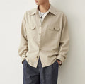 Men's light sand rice coloured lapel shirt with long sleeves on a hanger