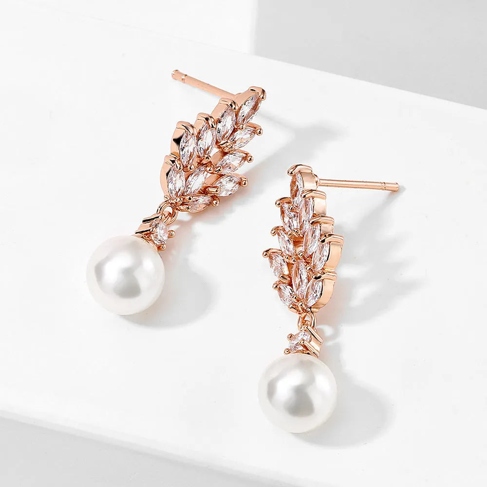Geometric floral earrings with micro inlaid zircon and pearl details on copper with gold plating