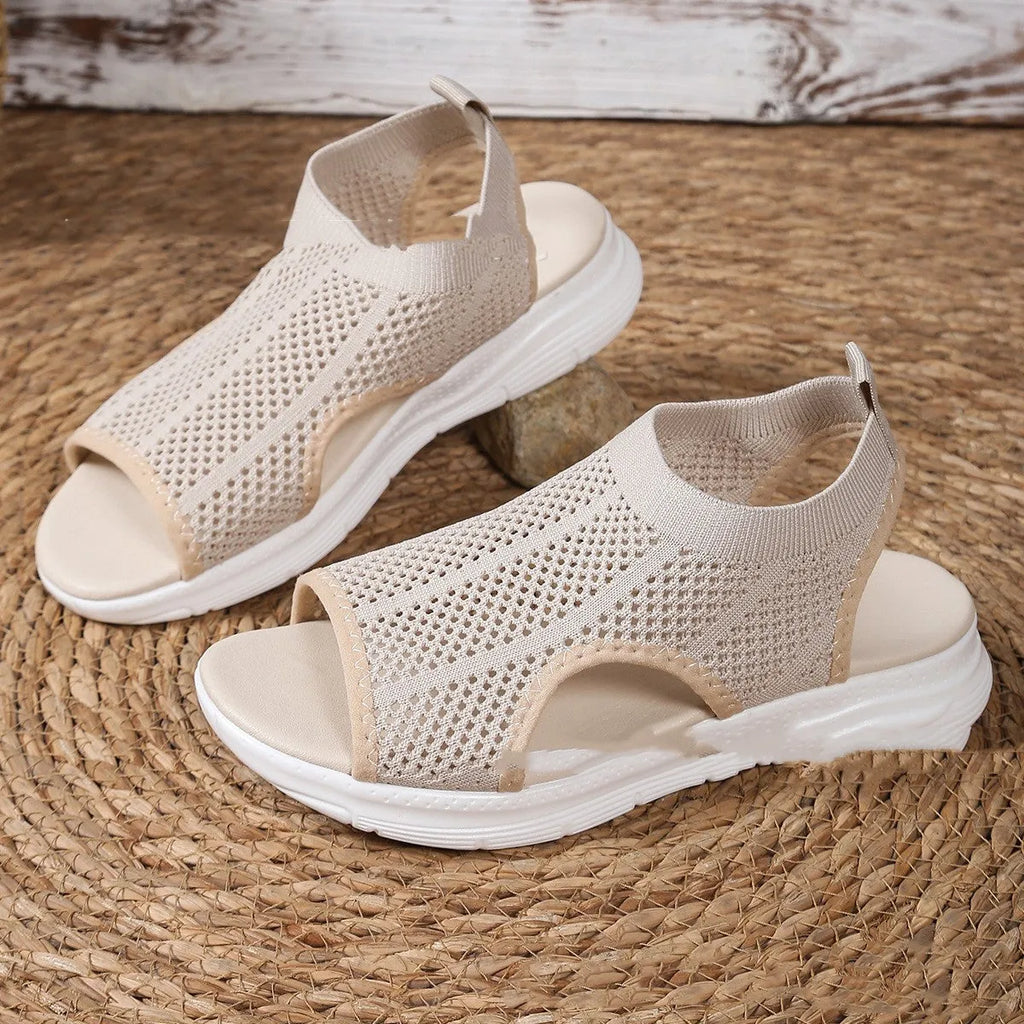 Women's platform sports sandals in black with a flat rubber sole and mesh lining.