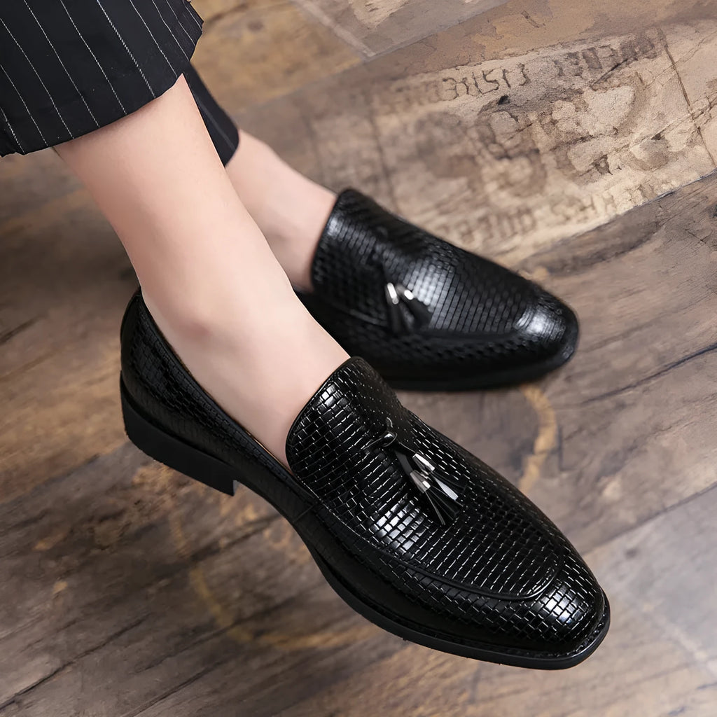 Men's black pointed toe slip-on loafers with a tassel detail on the artificial PU upper.