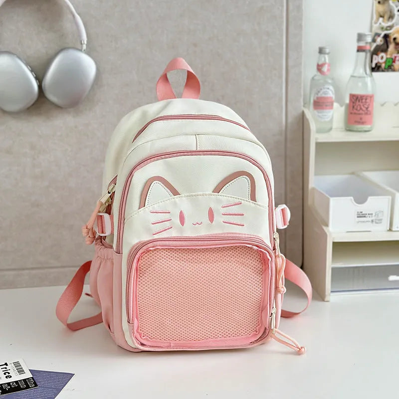 Cartoon style large capacity nylon backpack in pink with badge pendant, showing curved shoulder straps