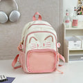Cartoon style large capacity nylon backpack in pink with badge pendant, showing curved shoulder straps