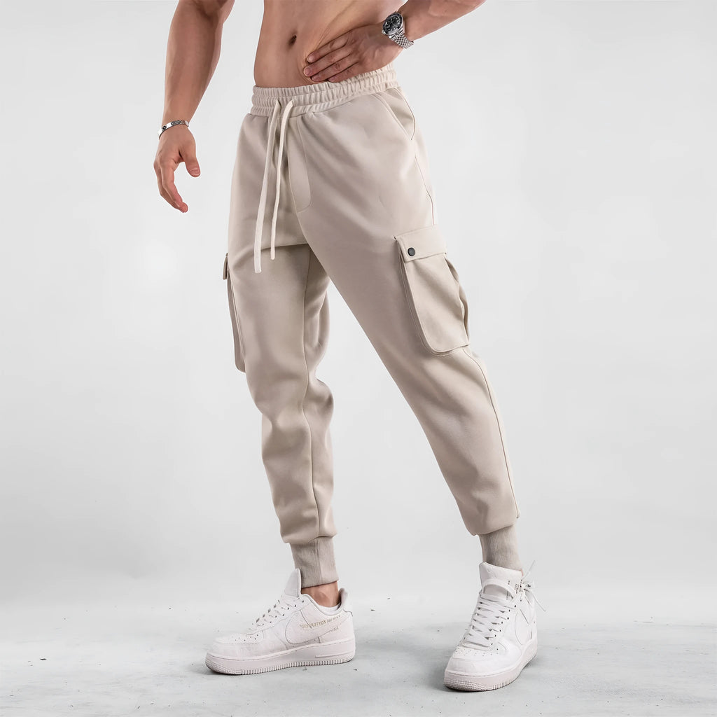 Men's loose-fit ankle-tied cotton sports trousers in solid colour with multi-pocket design