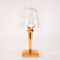 Rose gold portable touch control night light on a table.