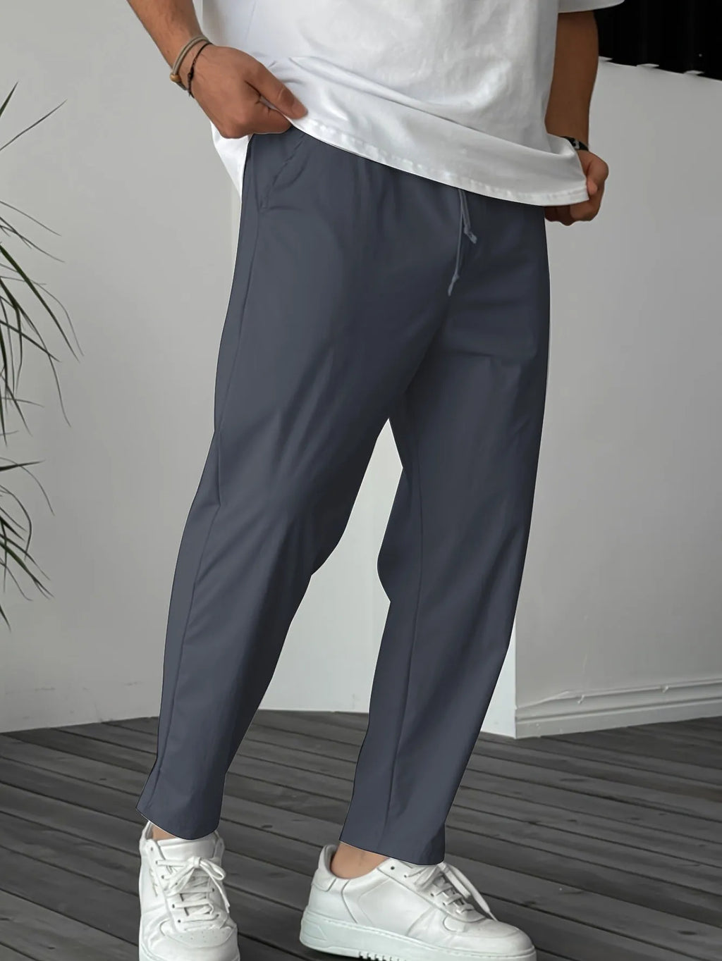 Men's khaki straight-leg casual trousers with a drawstring waist and a decorative ribbon pocket detail.