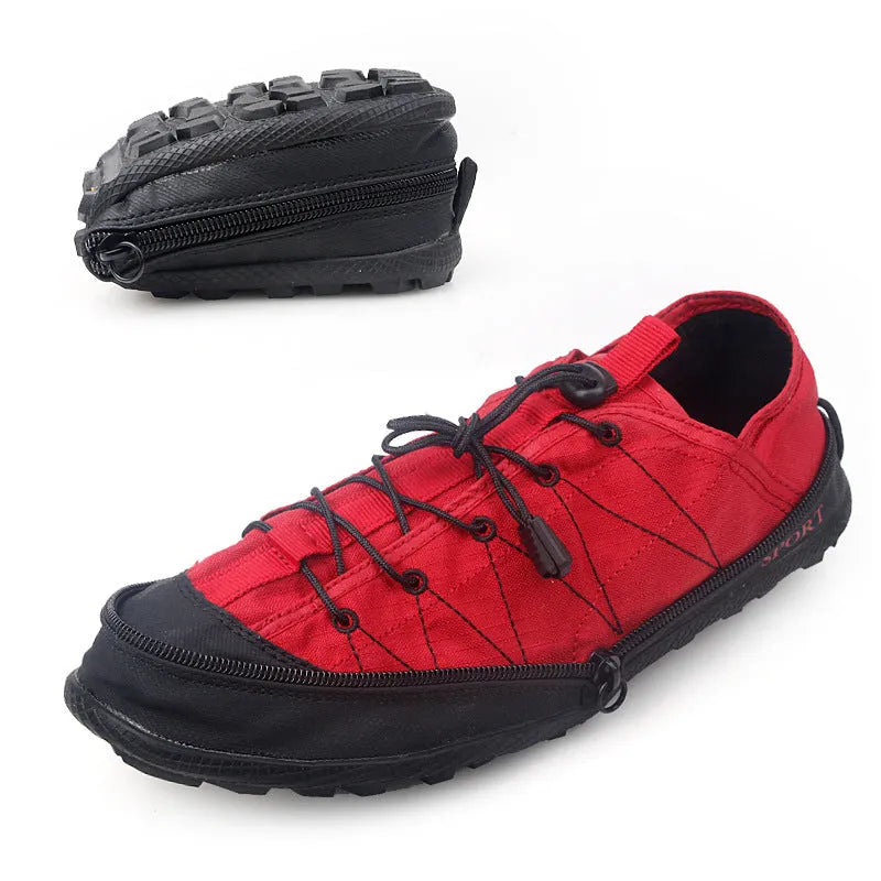 A pair of orange folding outdoor hiking shoes with a mesh upper and a prominent side zipper, shown in a collapsed state.