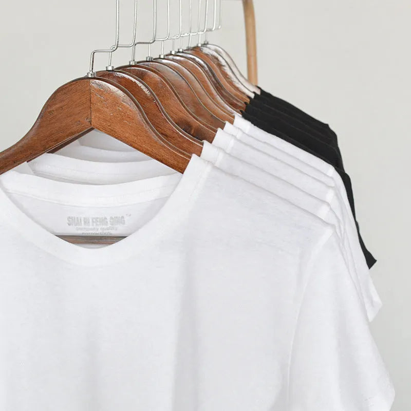 Men's solid colour round neck cotton T-shirt on a hanger, showing short sleeve and casual pullover style.