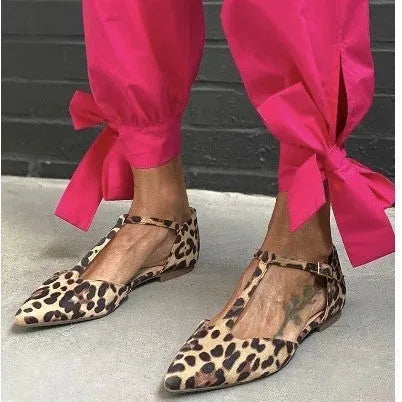 Leopard print women's pointed toe pumps with a chunky low heel and a cross ankle strap