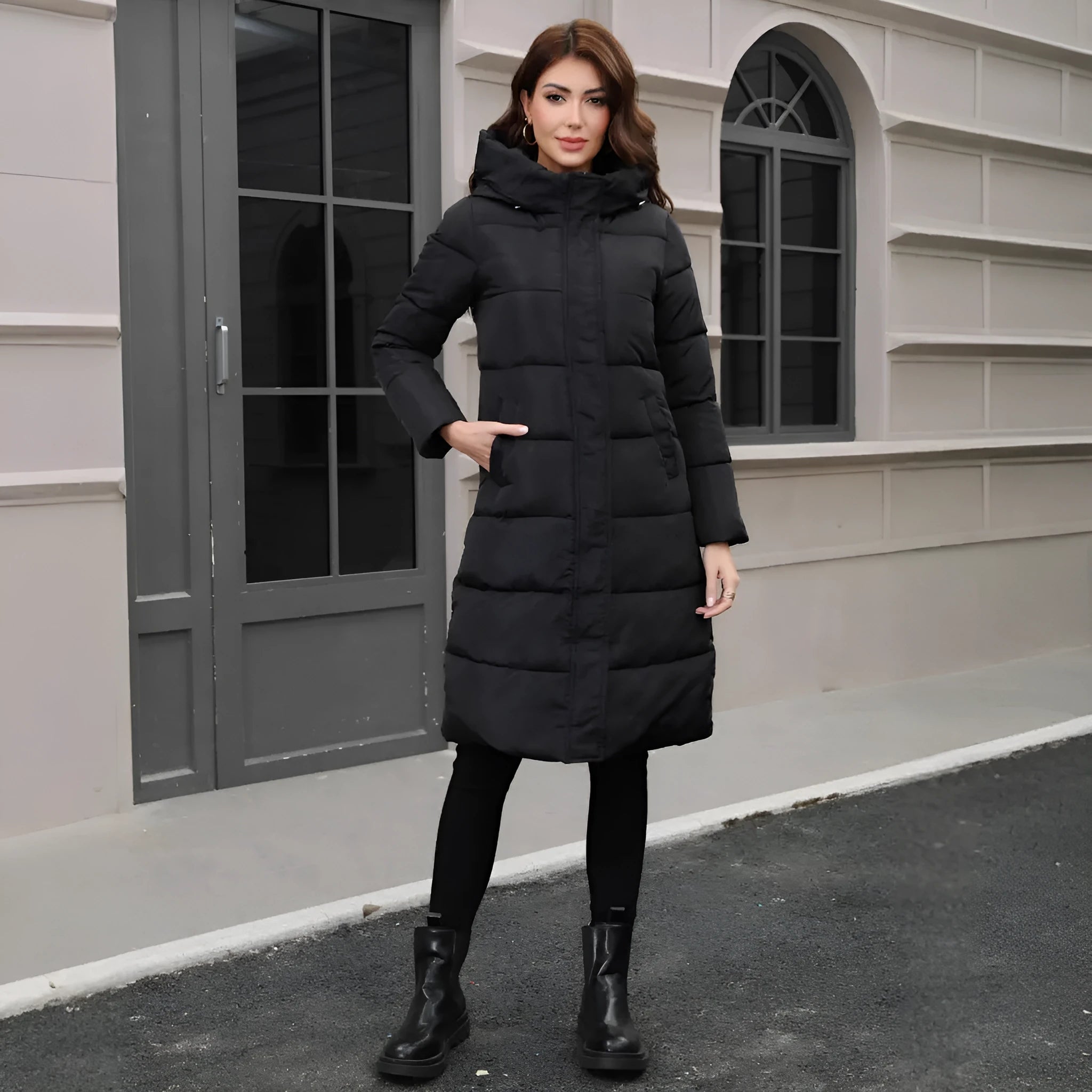 Black slim fit hooded long jacket on a model, showing tapered silhouette and regular sleeves