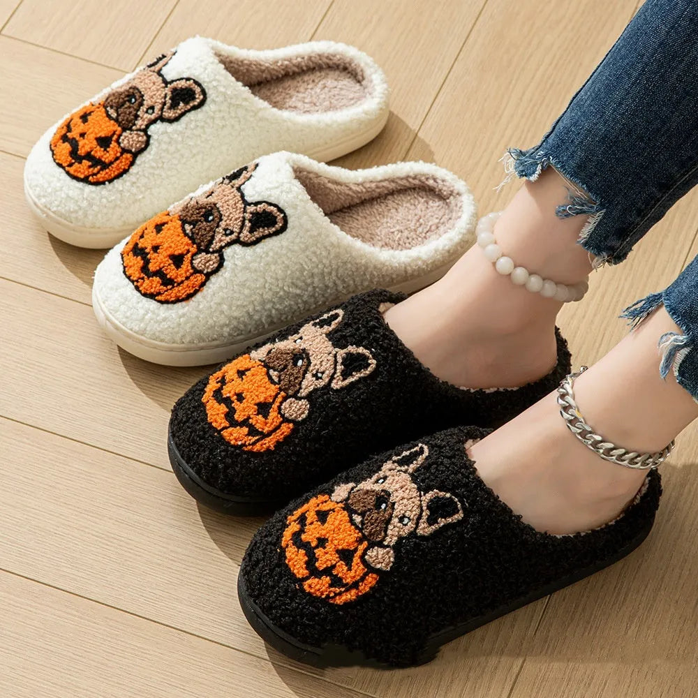 Black and white Halloween slippers with pumpkin design, plush upper, and textured TPR non-slip sole.