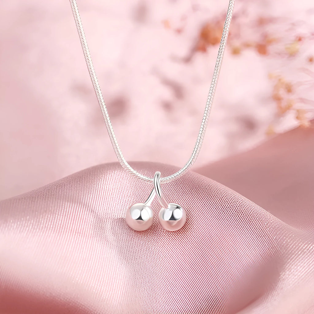 Silver cherry necklace for women with adjustable snake bone chain and fruit-shaped pendant.