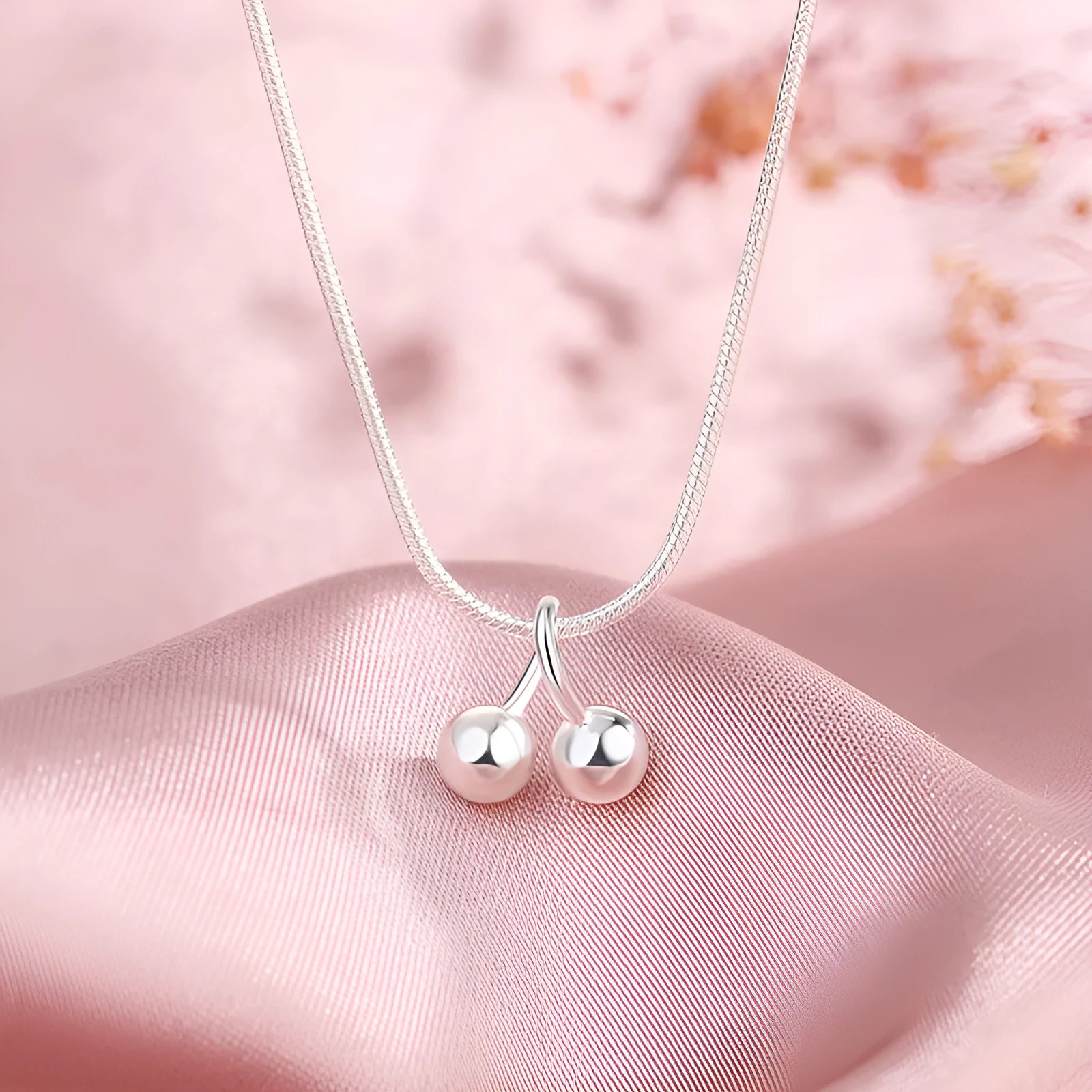 Silver cherry necklace for women with adjustable snake bone chain and fruit-shaped pendant.