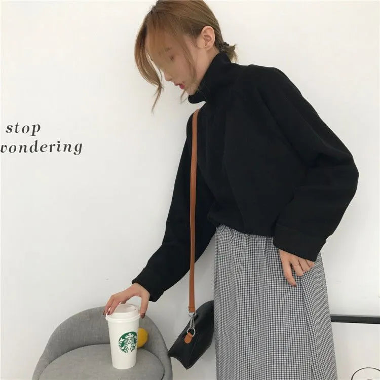 Women's solid colour loose-fit polyester top with half-high collar and long sleeves.