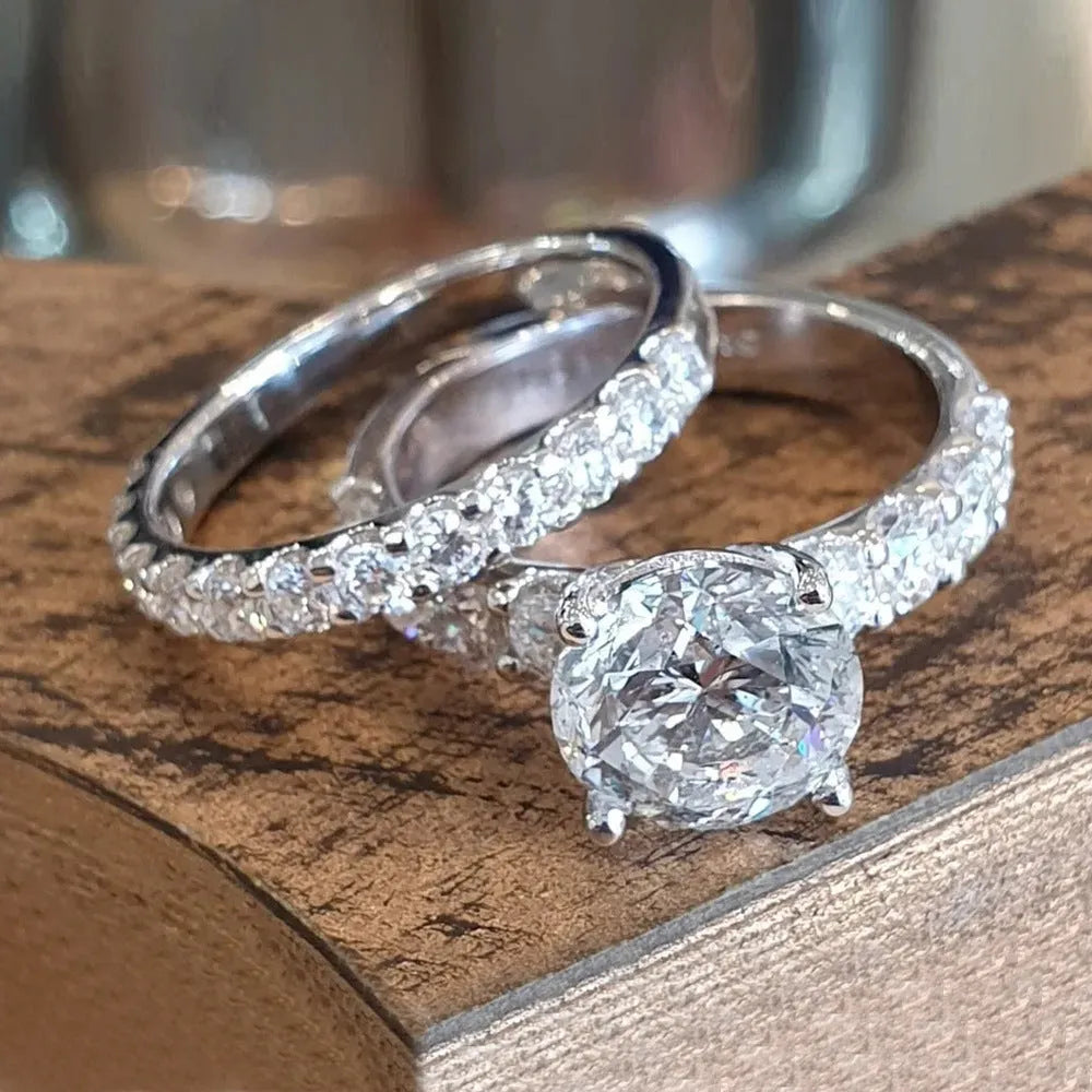 Two matching copper couple rings with a white gold finish and a small zircon stone inlay on a white background