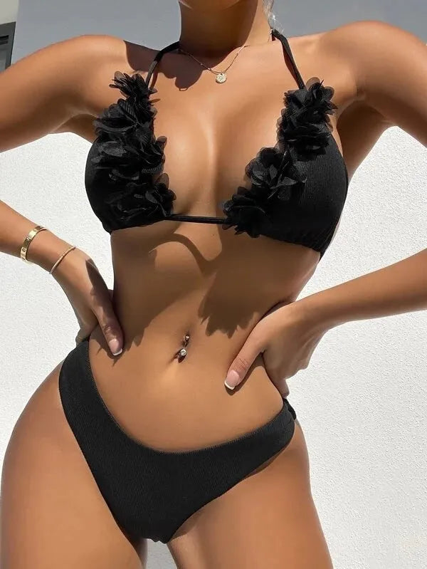 Black women's two-piece polyester swimsuit set with top and shorts on a mannequin