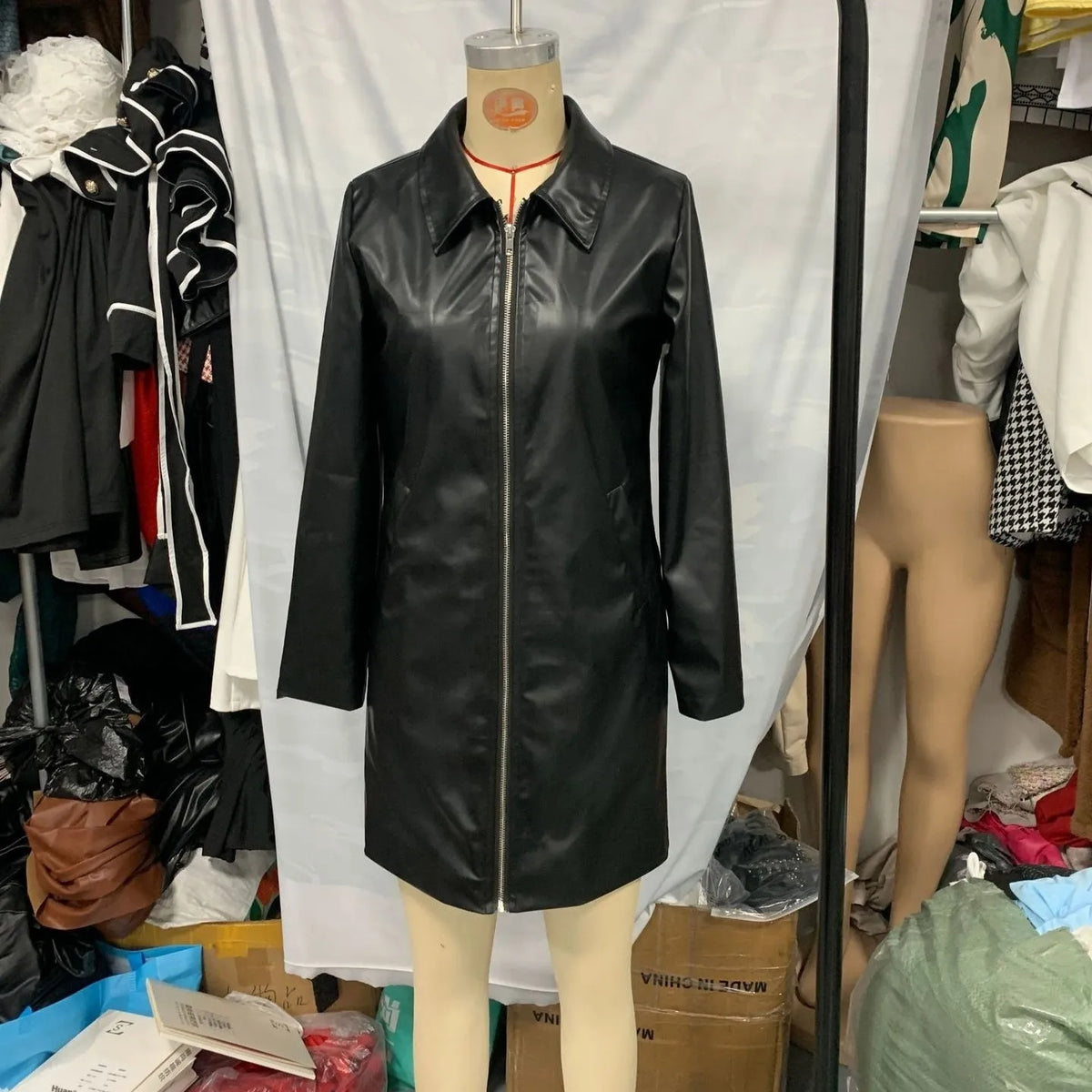 Solid black women's leather jacket with medium 65cm length and long sleeves
