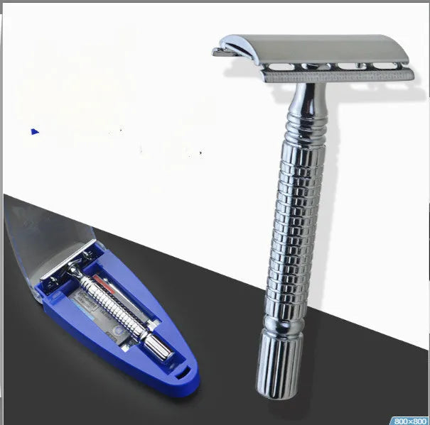 Double edged safety razor with metal handle and head next to its blade and storage box.