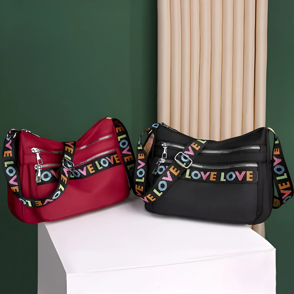 Oxford cloth crossbody shoulder bag in red or black with single strap, multi-pocket large capacity, and letter stitching details