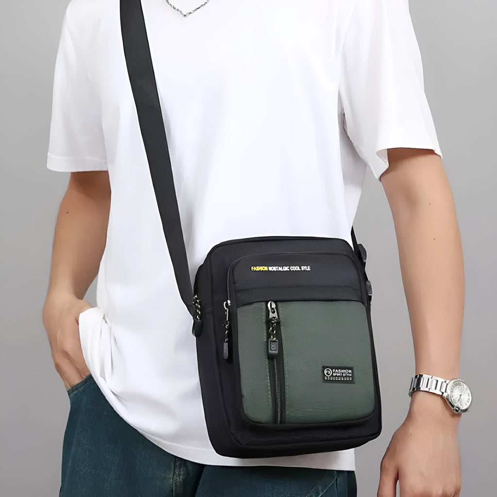 Men's green nylon crossbody messenger bag with one shoulder strap and sewing thread detailing