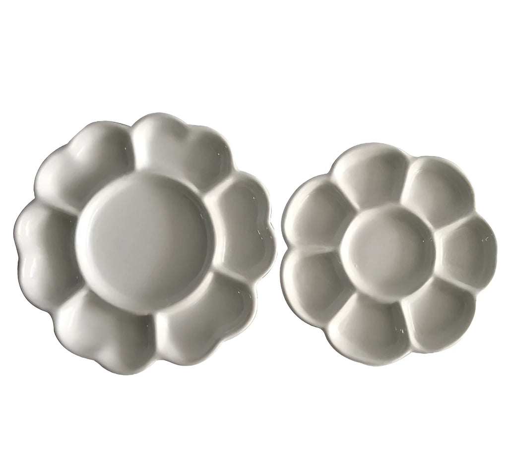 White handmade ceramic plum blossom shaped artist palette for painting.