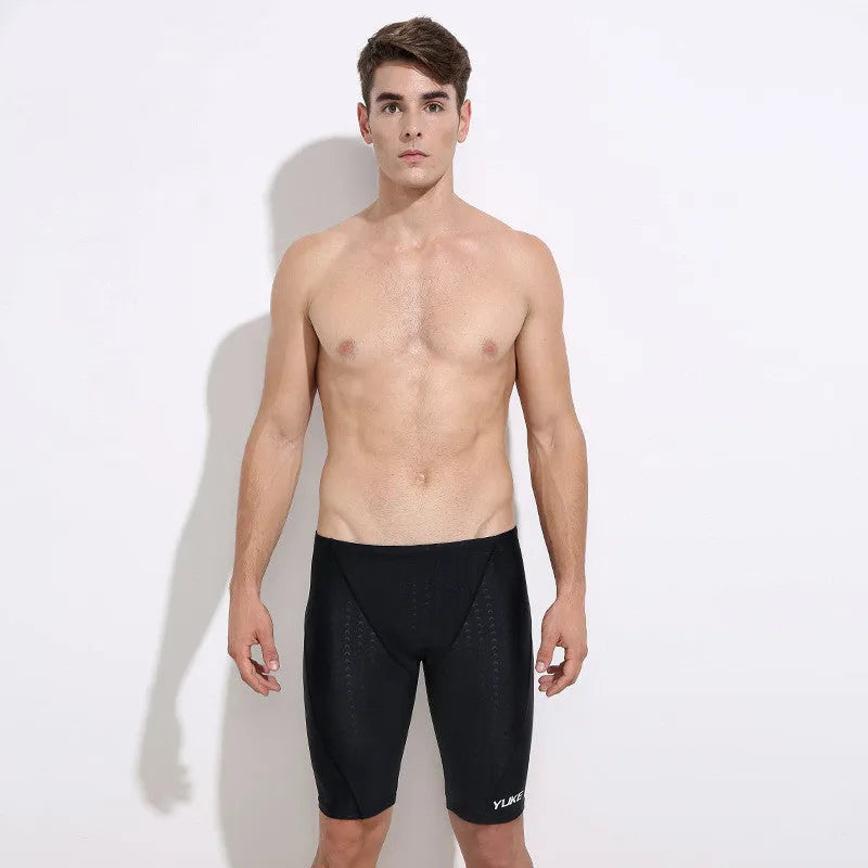 Men's black five-piece swimming set showing trunks, goggles, cap, ear plug nose clip and swimming bag