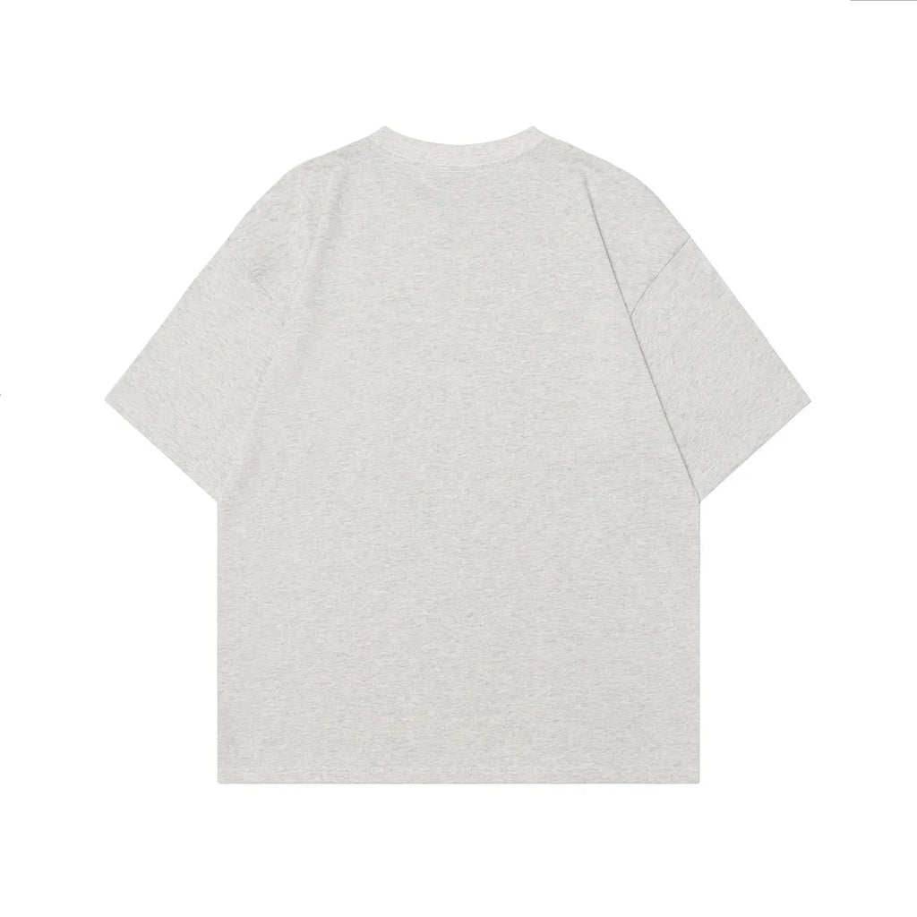 Men's grey cotton T-shirt with character design print showing loose fit and short sleeves