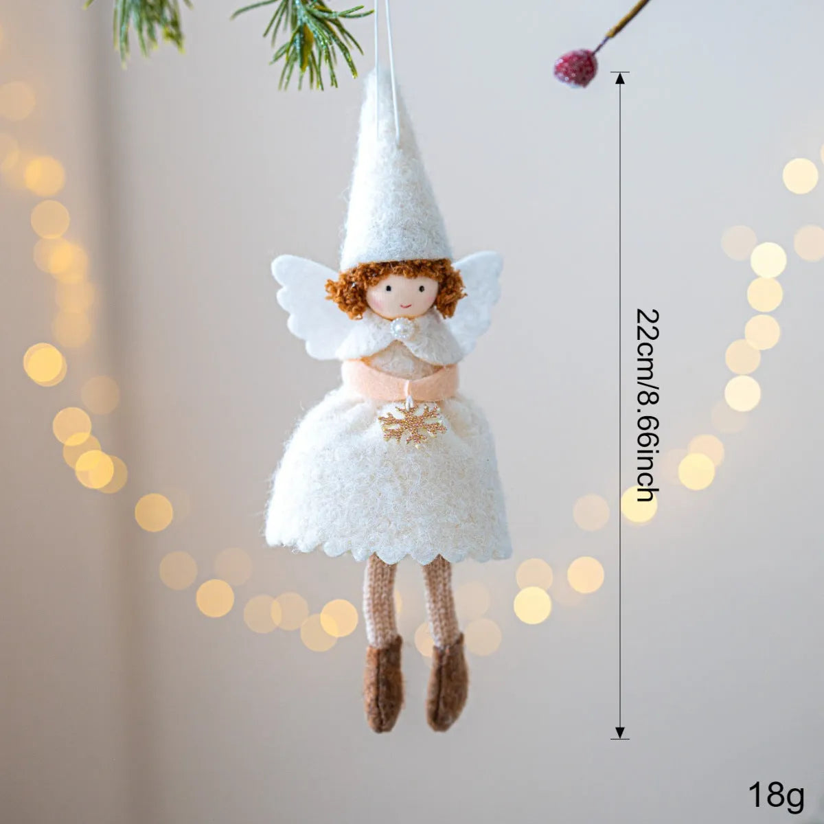 Close-up of a white cloth angel skirt felt pendant Christmas tree ornament.