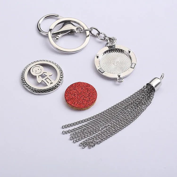 Silver alloy tassel car pendant on a chain with coloured scent cotton pads for essential oils.