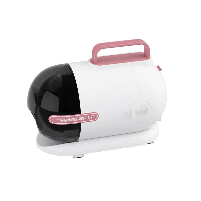 Pink and white pet hair vacuum cleaner with grooming clippers, hose, and attachments on white background