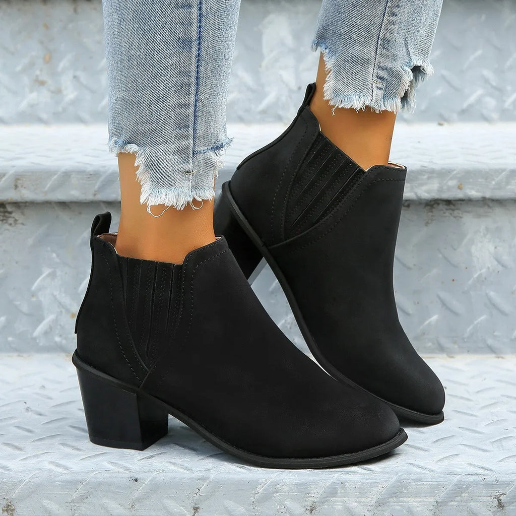 Women's black and brown pointed toe ankle boots with thick square heel and slip-on design made of artificial PU.