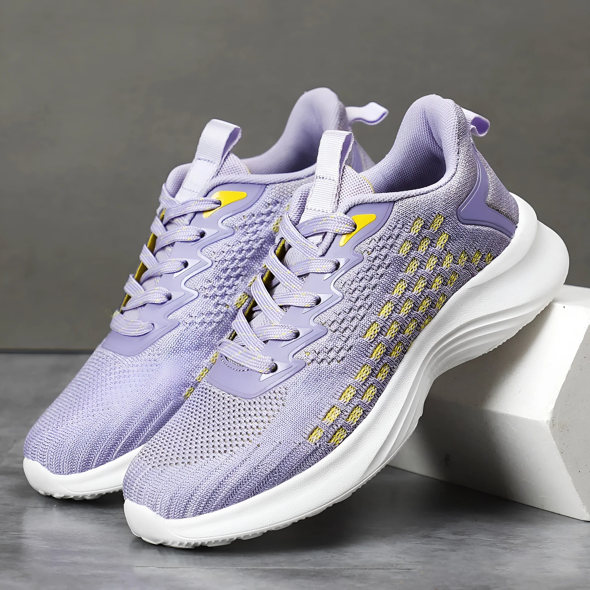 Women's lavender purple Flyknit running shoes with mesh lining and striped pattern on a white background.