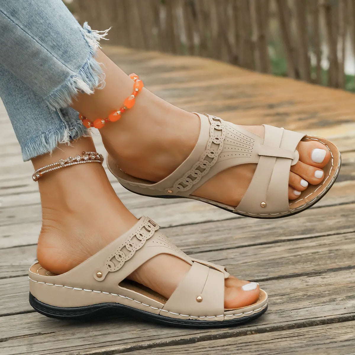 Blue Roman-style slippers with a fish mouth toe holder and slope heel on a rubber sole.