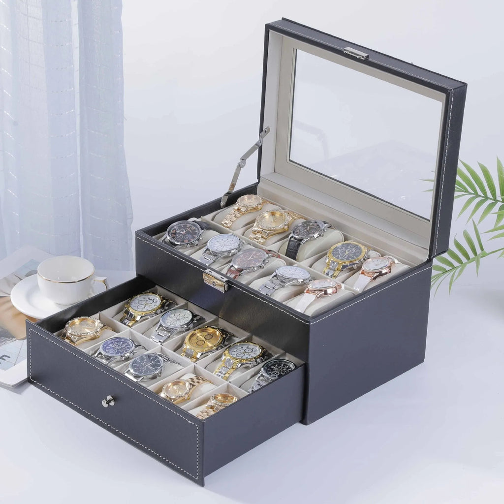 Grey leather watch storage box with see-through lid showing organised watch storage compartments