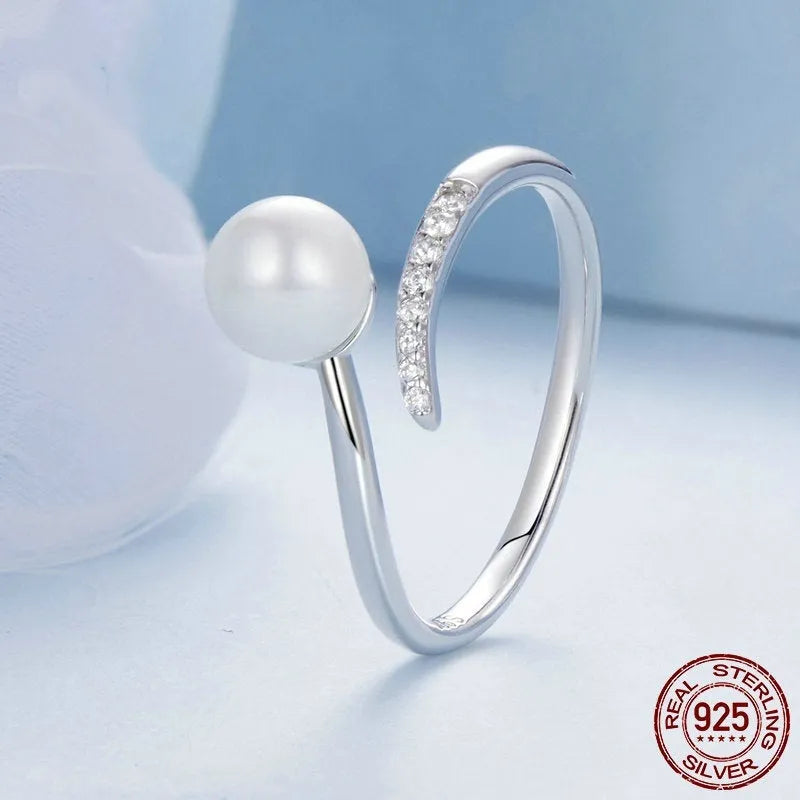 Sterling silver adjustable ring with shell pearls on open loop design