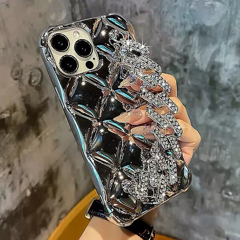 Gold diamond bracelet chain phone case for iPhone on a table.