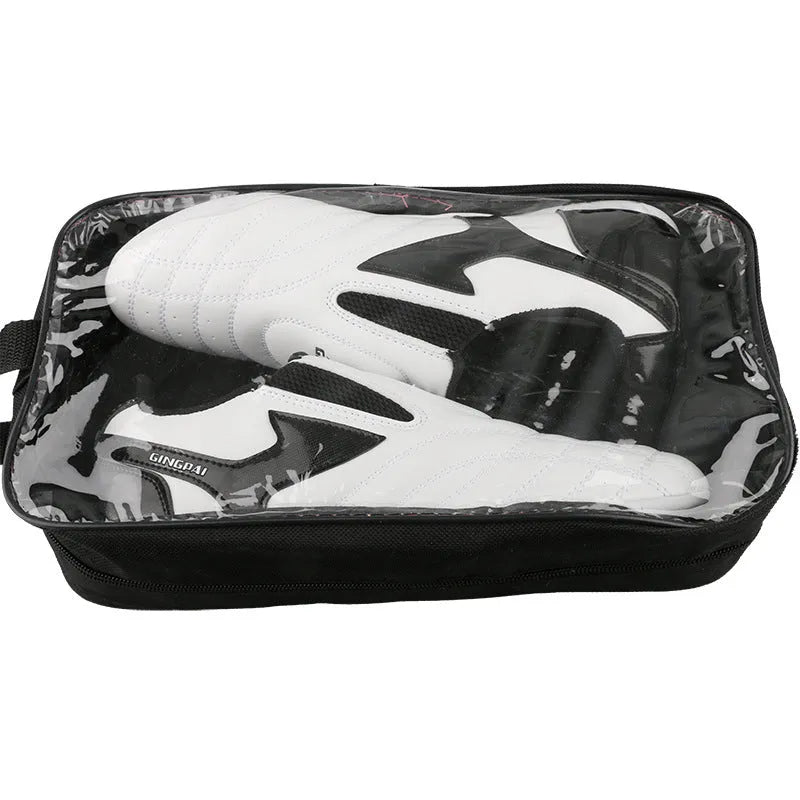 Black and white children's martial arts training shoes with soft bottom construction and widened design