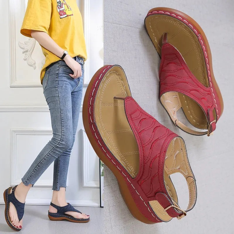 Women's wedge heel sandals with an adjustable buckle strap in a solid colour