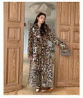Women's artificial fur coat with collar in street fashion style showing pocket detailing