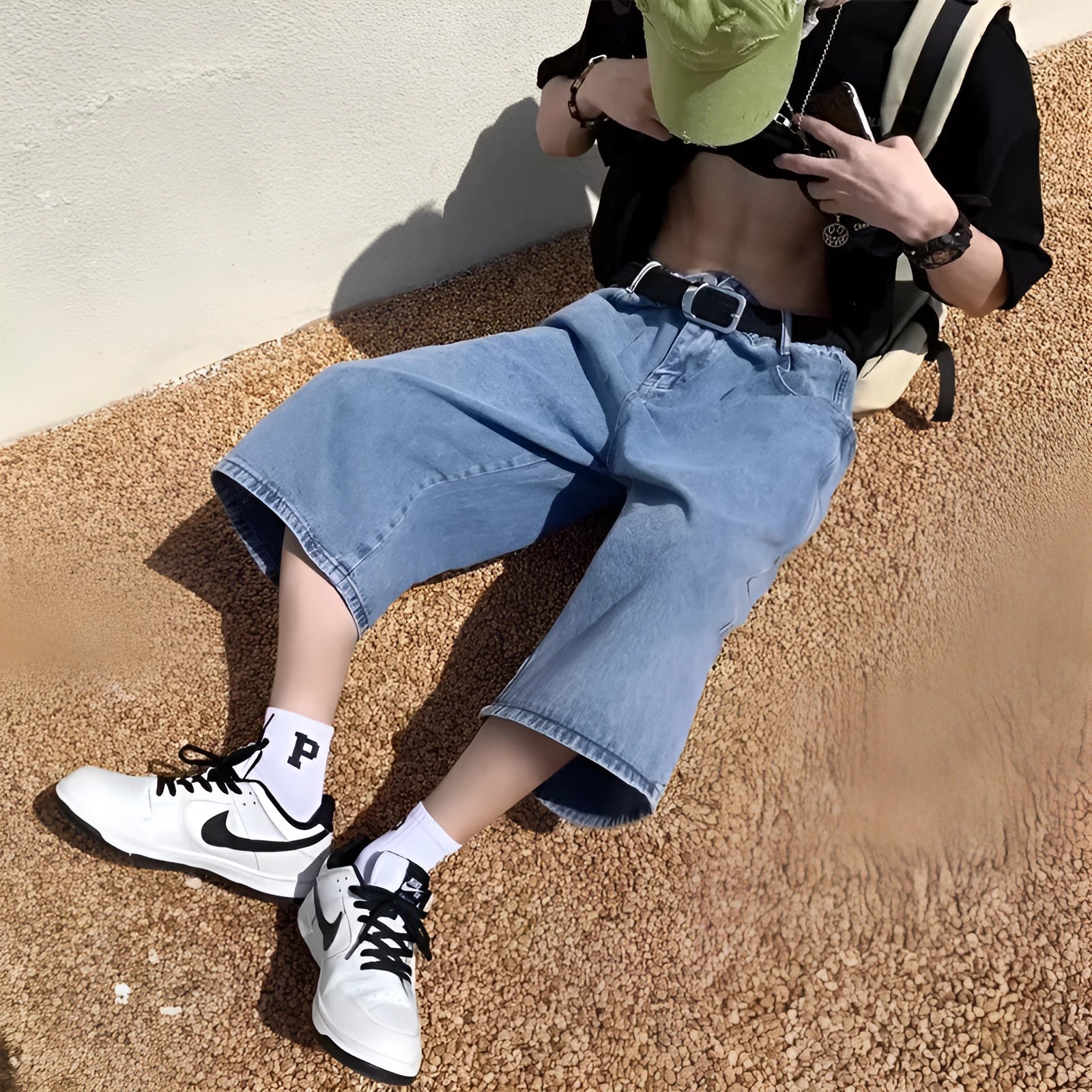 Blue washed denim shorts for men with a high waist, cropped length, and front zip fly.