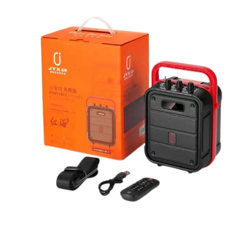 MS62AI portable Bluetooth speaker with wireless microphone on a table, showing control knob and plastic casing.